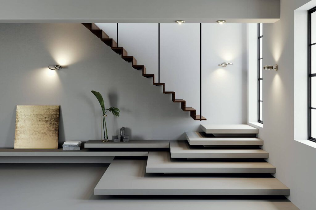 Lodes Nautilus wall lights lighting a floating concrete staircase in a modern white home