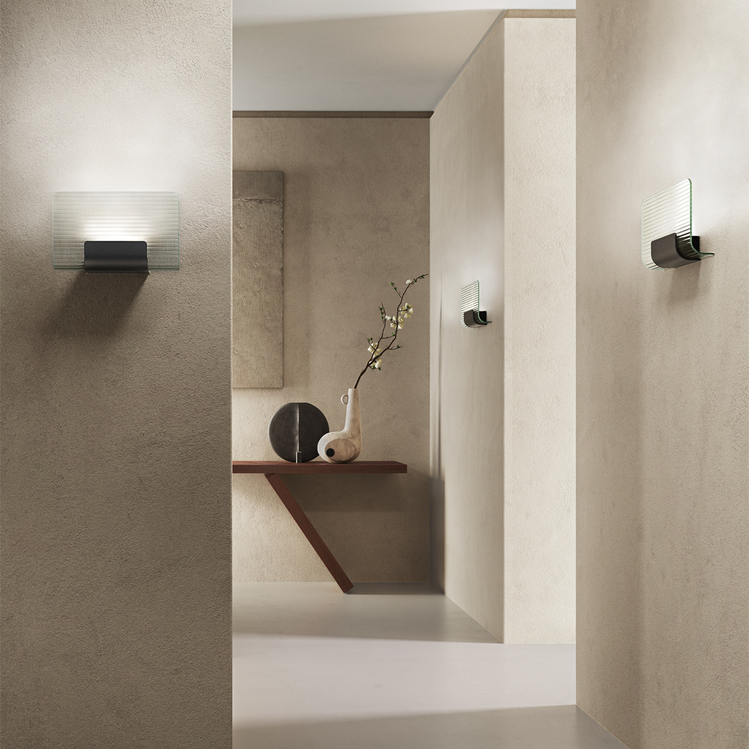 KDLN Nami wall sconces glowing softly in a modern interior with pale stone walls