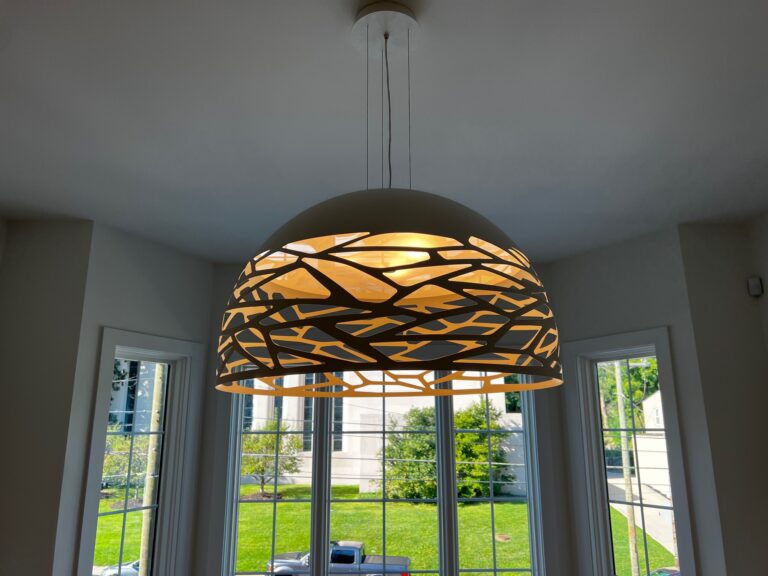 Kelly Dome over a dining table under a vaulted ceiling
