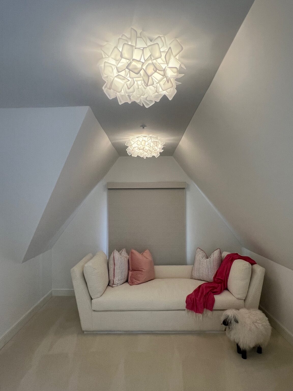 Slamp Clizia ceiling light in a sloped-ceiling sitting room