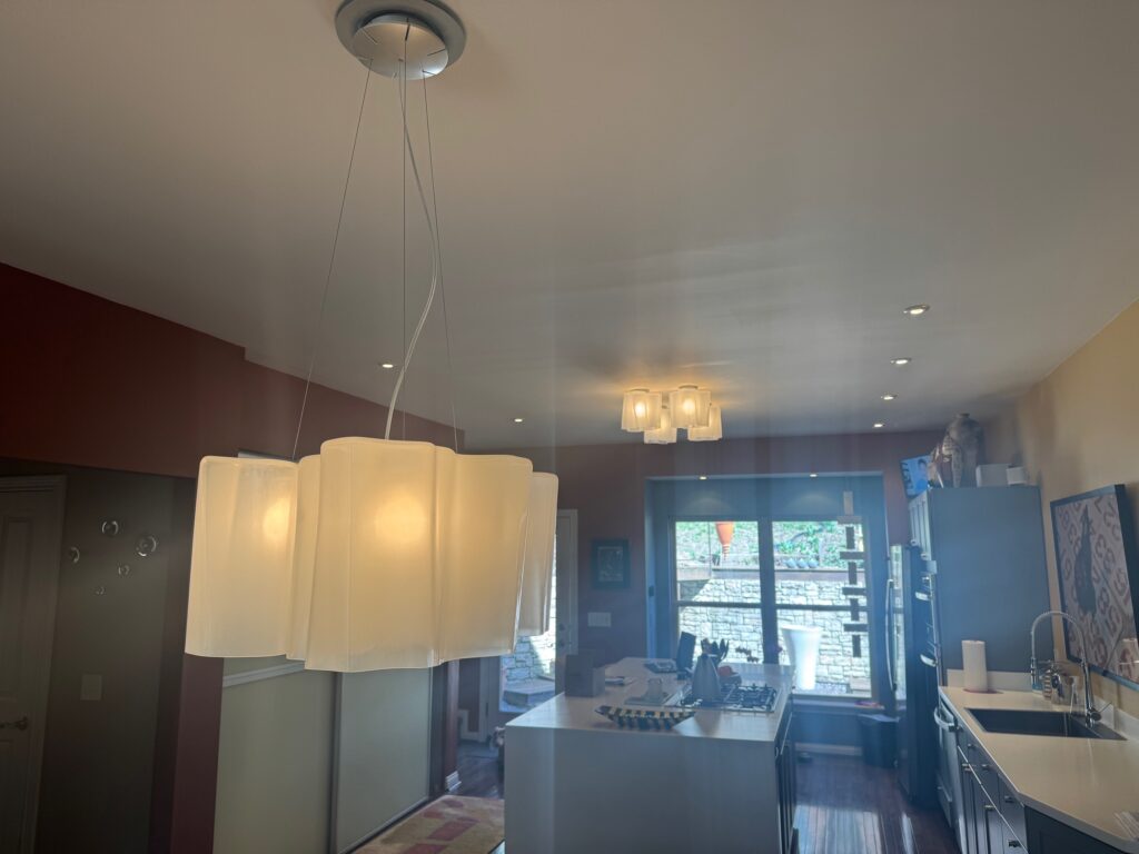 Artemide Logico triple pendant and ceiling lights in a kitchen
