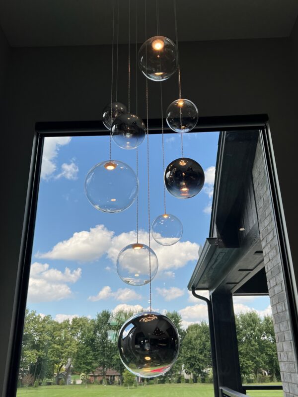 Random Solo globes floating in front of a tall window
