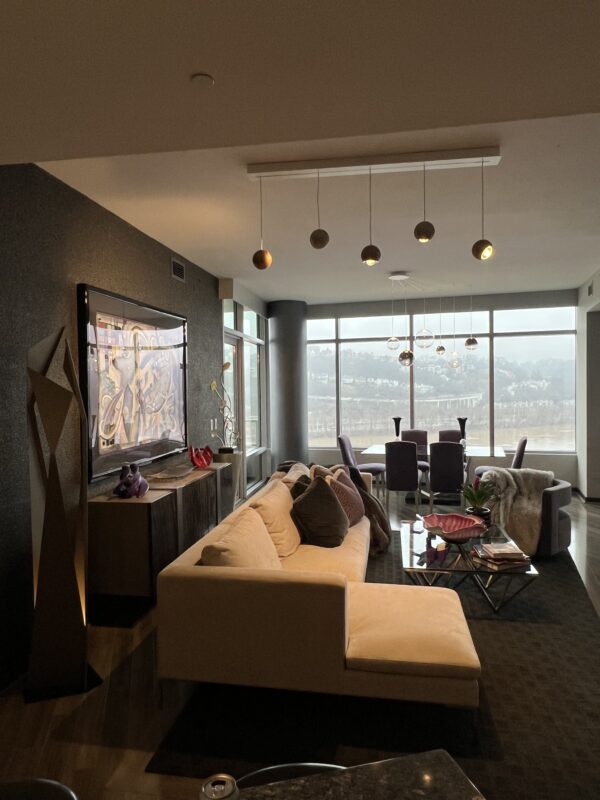 Spider pendants over a dining table in a high-rise living room