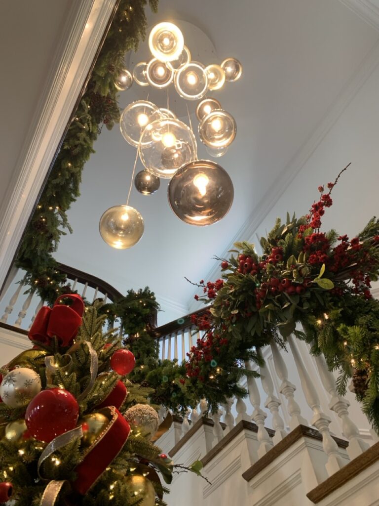 Random Solo spheres over a stair rail dressed in holiday garland