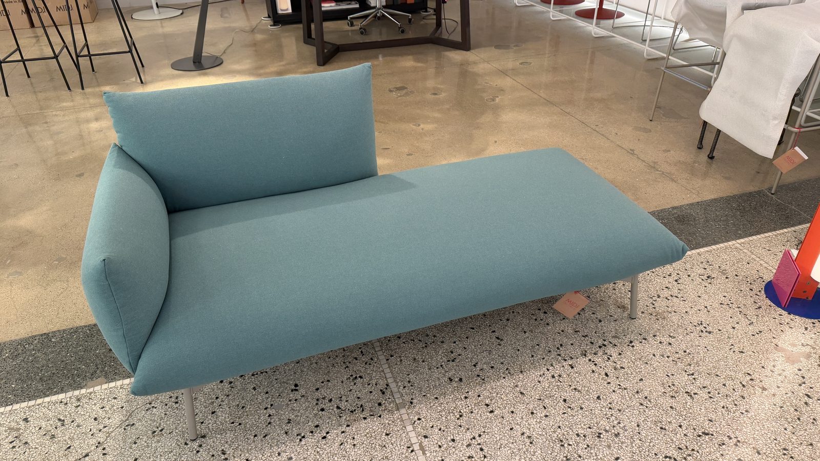 Three-quarter view of the Midj Area Chaise showing its half-back and single arm cushion
