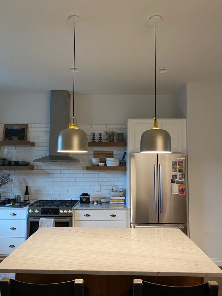 JIM bells over a white kitchen island
