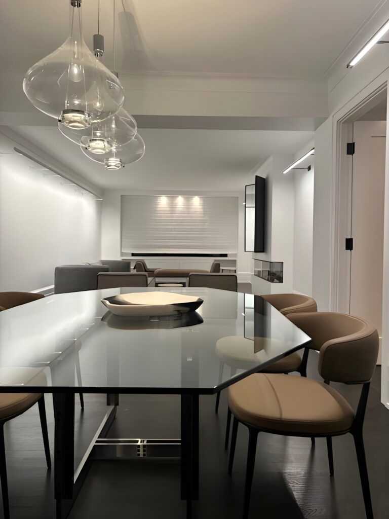 Clear Sky-Fall pendants over a glass dining table in a New York apartment