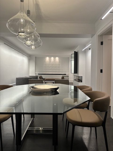 Clear Sky-Fall pendants over a glass dining table in a New York apartment