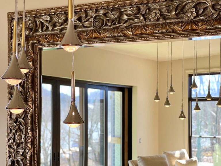 Rain pendants framed by a carved mirror