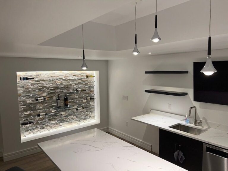 Matte black Rain pendants over the bar in a suburban basement remodel