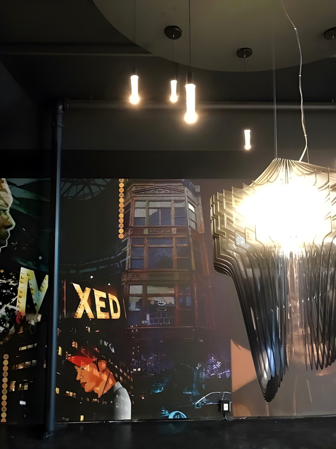 Slamp Aria pendant glowing in a dark space on Vine Street