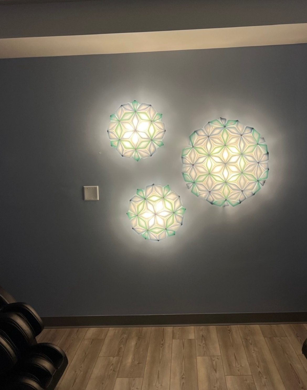 Three Slamp La Vie wall lights on a blue wall